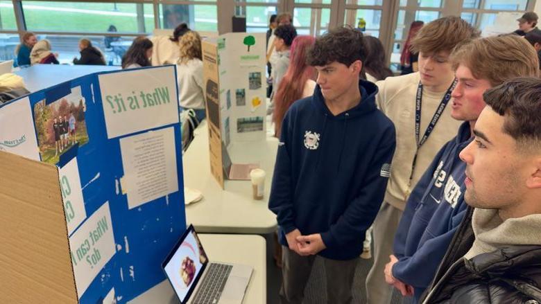 Students looking at a poster display